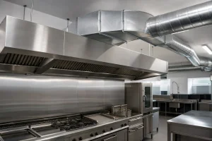 Commercial kitchen canopy connected to rectangular and spiral ductwork.