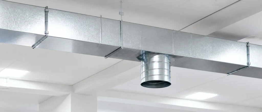 Clean commercial ceiling with finished rectangular and spiral ductwork.