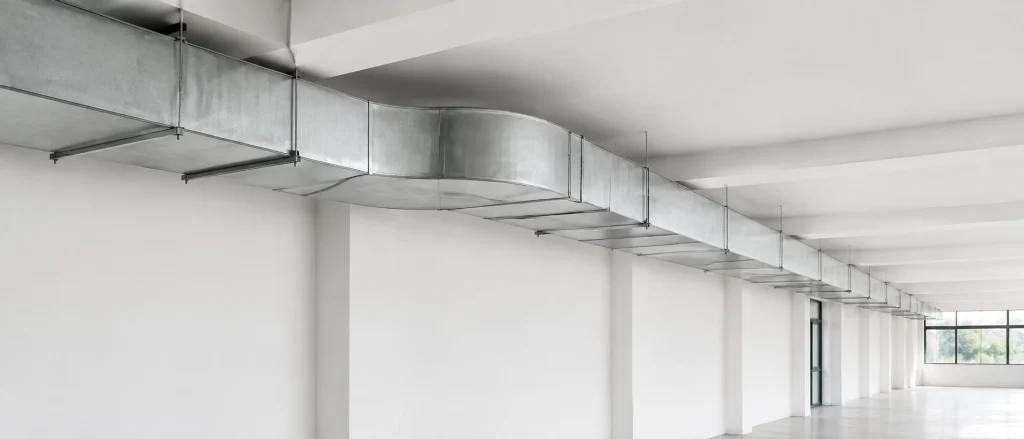 Clean rectangular ventilation ductwork in a commercial interior.