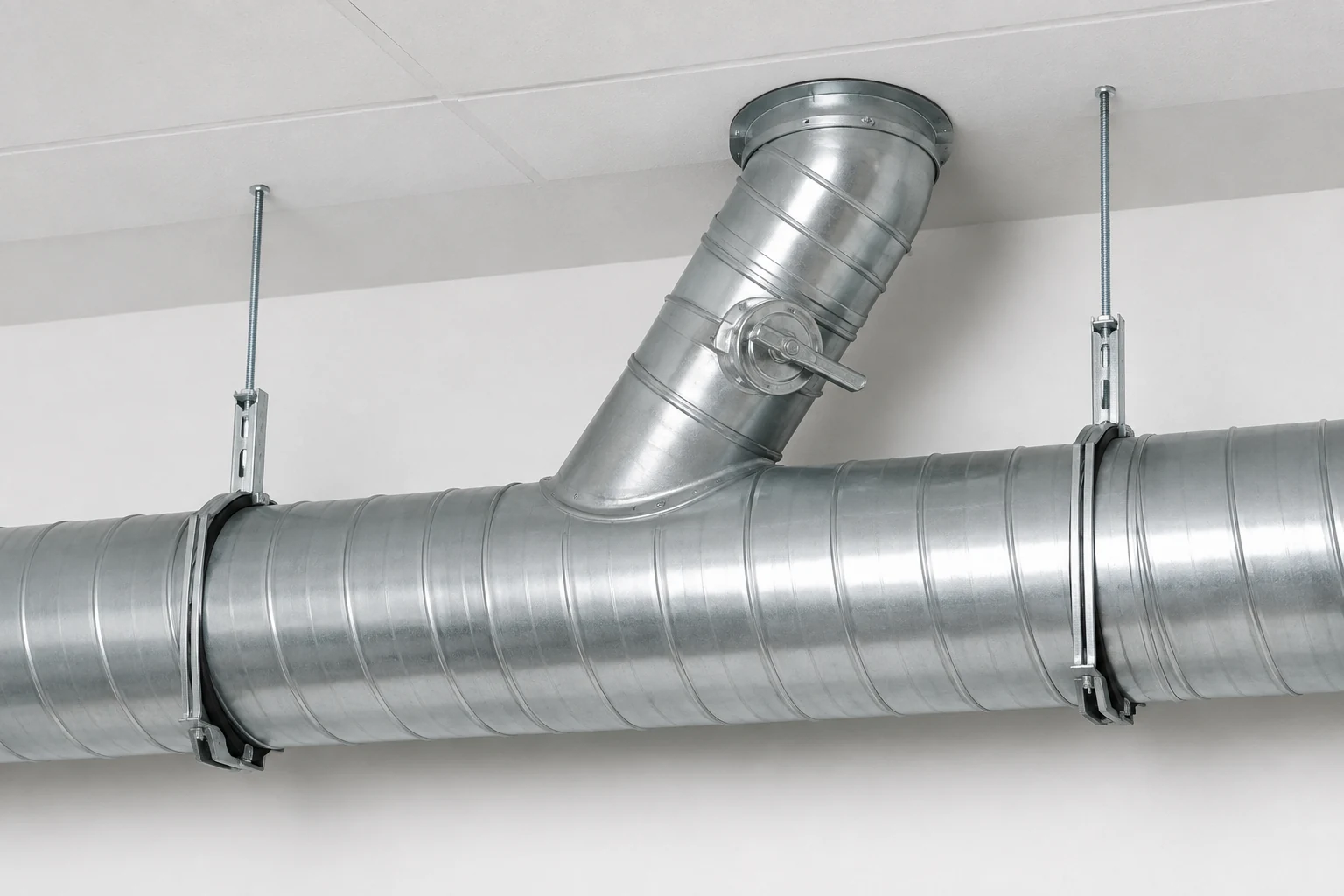 Spiral duct branch with a volume control damper.