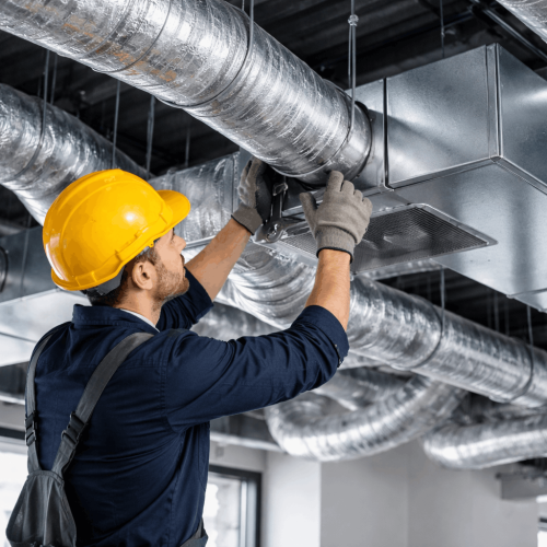HVAC technician installing ventilation system